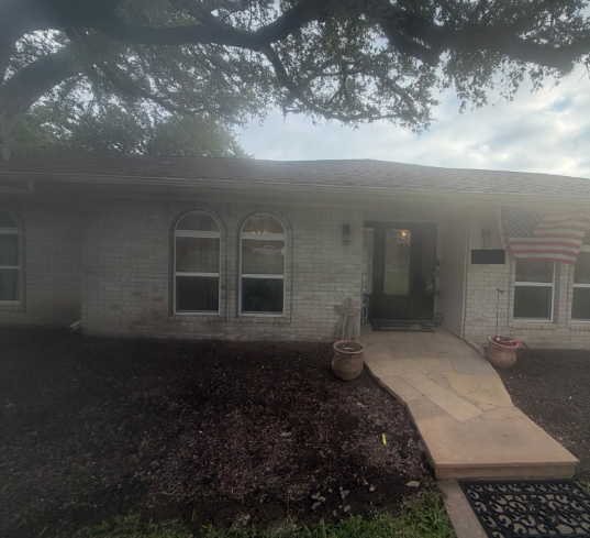 Before construction, the recessed doorway opened onto a smaller entry area beside the front planting beds.
Before construction, the recessed doorway opened onto a smaller entry area beside the front planting beds.