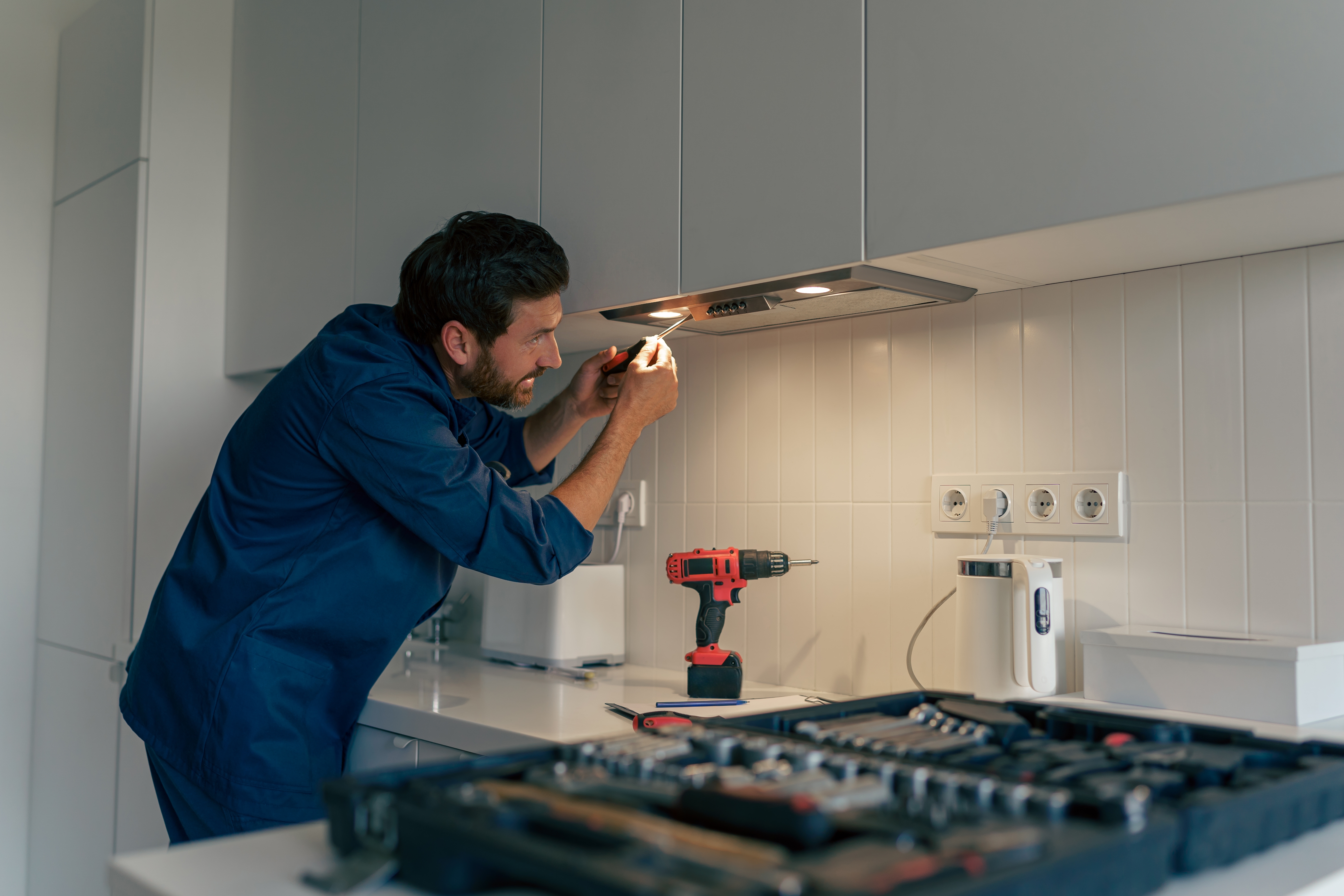 Handyman changing light fixture